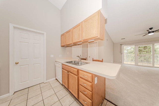 kitchen featuring a sink, a peninsula, light brown cabinetry, a ceiling fan, and light countertops