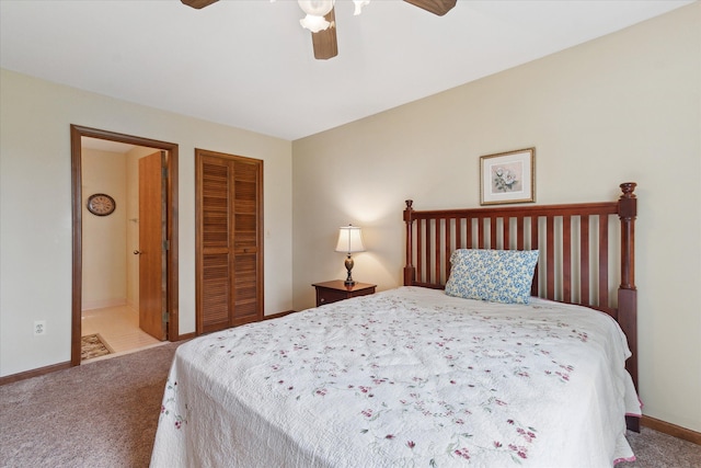 carpeted bedroom with baseboards, connected bathroom, ceiling fan, and a closet