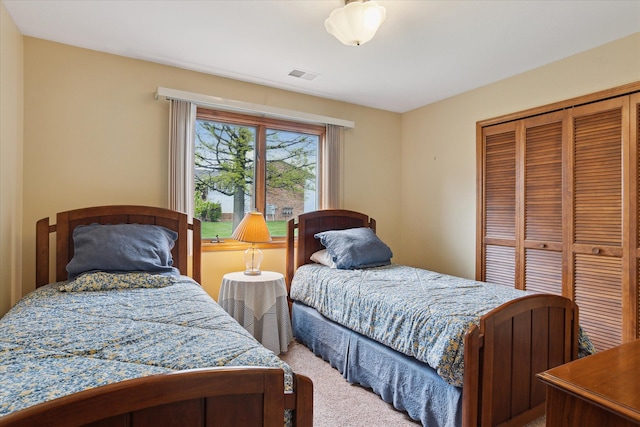 bedroom with carpet flooring and a closet