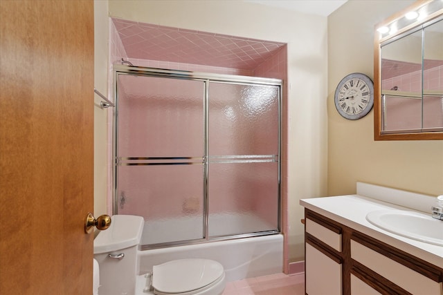 full bathroom featuring toilet, enclosed tub / shower combo, and vanity
