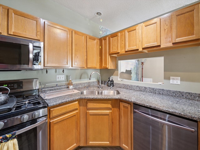 49559 Donovan Blvd, Plymouth, MI 48170 - kitchen featuring appliances with stainless steel finishes, a sink, light stone counters, and a textured ceiling