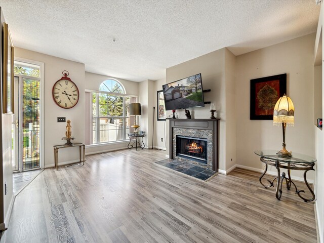 49559 Donovan Blvd, Plymouth, MI 48170 - living area with a textured ceiling, wood finished floors, a fireplace, and baseboards