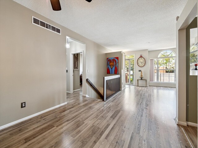 49559 Donovan Blvd, Plymouth, MI 48170 - empty room with a textured ceiling, ceiling fan, wood finished floors, and baseboards