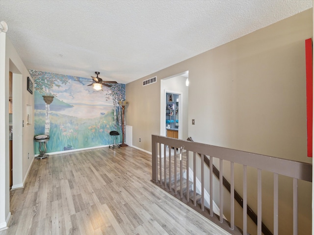 49559 Donovan Blvd, Plymouth, MI 48170 - unfurnished room featuring wood finished floors, ceiling fan, baseboards, and a textured ceiling