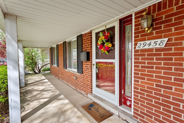 29458 Walker Dr, Warren, MI 48092 - entrance to property featuring a porch, brick siding, and a carport