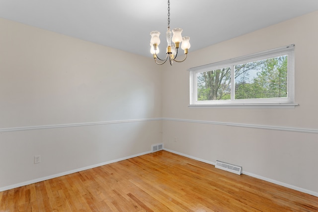 29458 Walker Dr, Warren, MI 48092 - unfurnished room featuring a chandelier, baseboards, and light wood finished floors