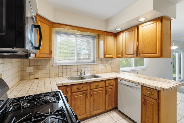 29458 Walker Dr, Warren, MI 48092 - kitchen featuring dishwasher, a sink, a peninsula, backsplash, and brown cabinets