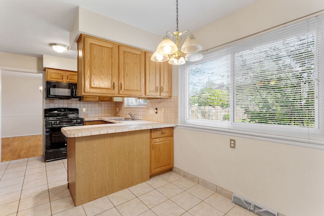 29458 Walker Dr, Warren, MI 48092 - kitchen featuring black appliances, tile countertops, a chandelier, and light tile patterned floors