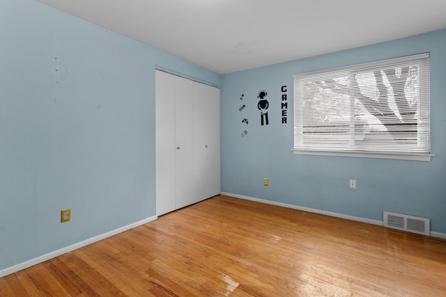 29458 Walker Dr, Warren, MI 48092 - unfurnished bedroom with light wood finished floors, baseboards, and a closet