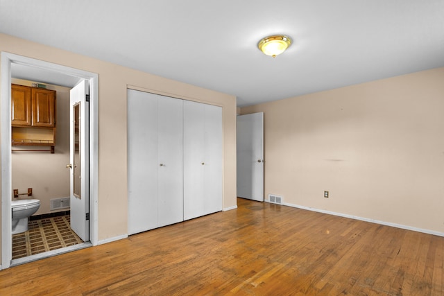 29458 Walker Dr, Warren, MI 48092 - unfurnished bedroom with wood finished floors, a closet, ensuite bath, and baseboards