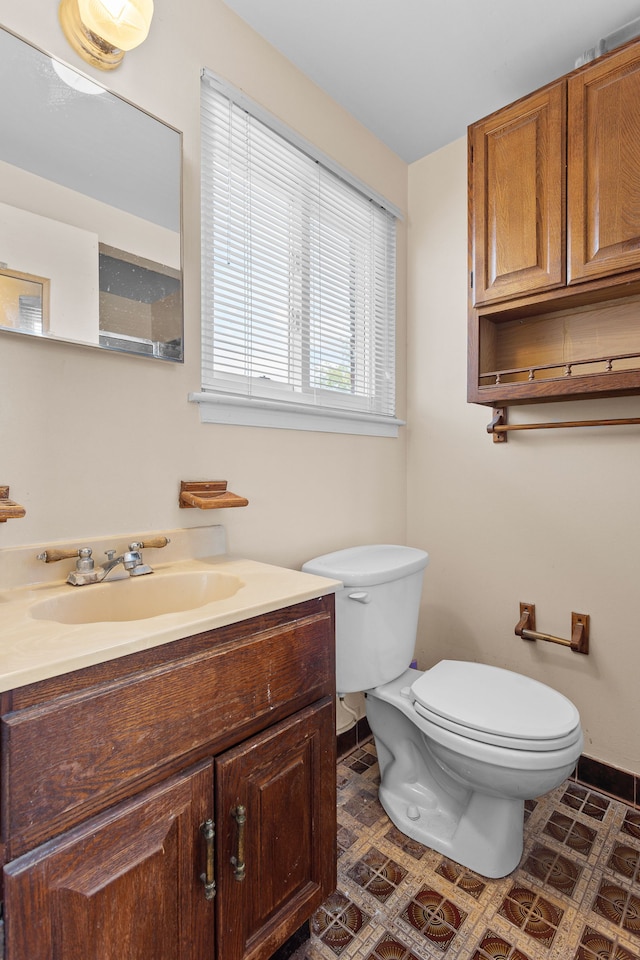 29458 Walker Dr, Warren, MI 48092 - half bathroom featuring toilet, vanity, and baseboards