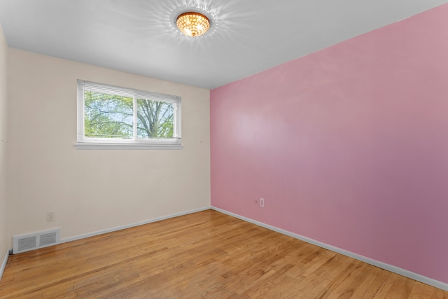 29458 Walker Dr, Warren, MI 48092 - spare room with light wood finished floors, baseboards, and a chandelier