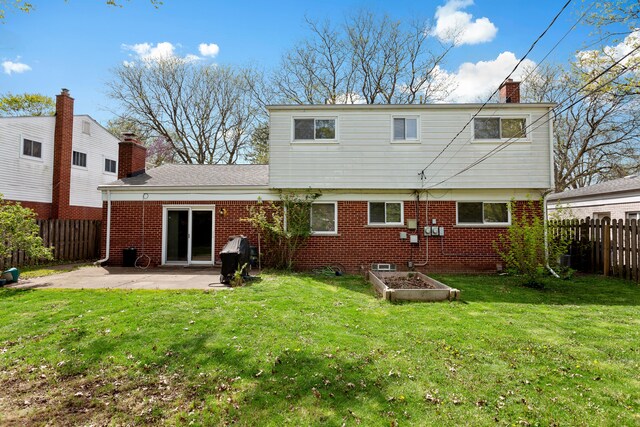 29458 Walker Dr, Warren, MI 48092 - rear view of property featuring a chimney, a patio, brick siding, and a garden