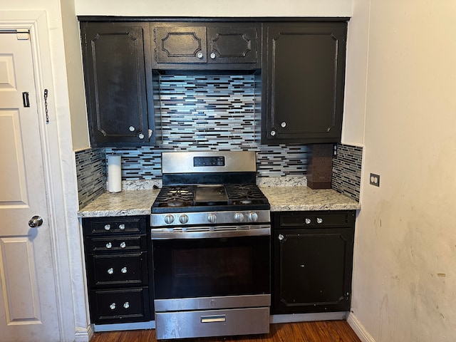 752 E Philadelphia Blvd, Flint, MI 48505 - kitchen featuring stainless steel range with gas cooktop, decorative backsplash, baseboards, and dark wood-type flooring