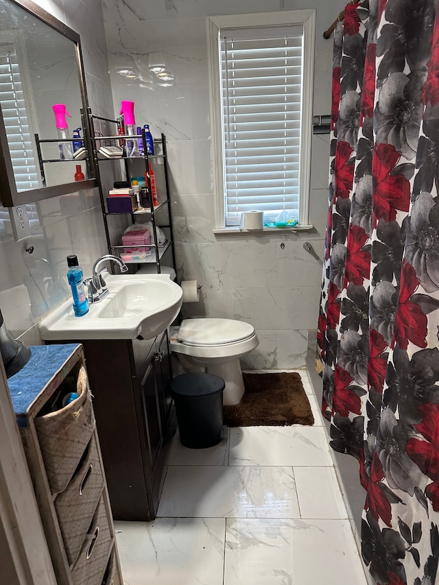 752 E Philadelphia Blvd, Flint, MI 48505 - bathroom featuring vanity, tile walls, marble look tile flooring, toilet, and a shower with curtain