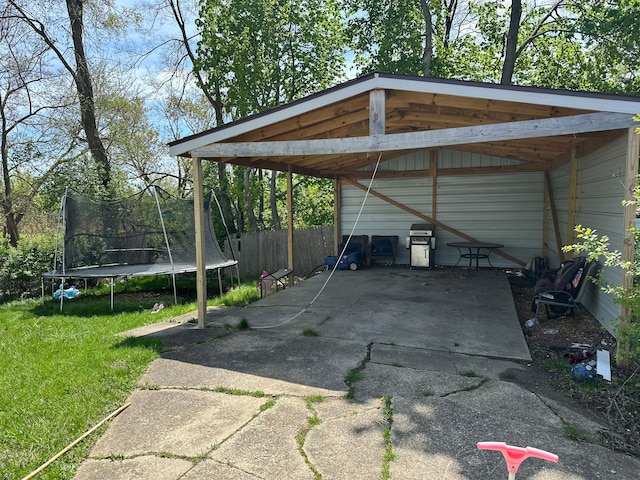 752 E Philadelphia Blvd, Flint, MI 48505 - view of parking / parking lot featuring a trampoline, a detached carport, and driveway