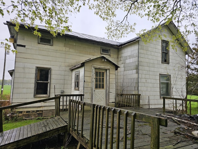 7697 Hogan Rd, Muir, MI 48860 - back of house with a deck and metal roof