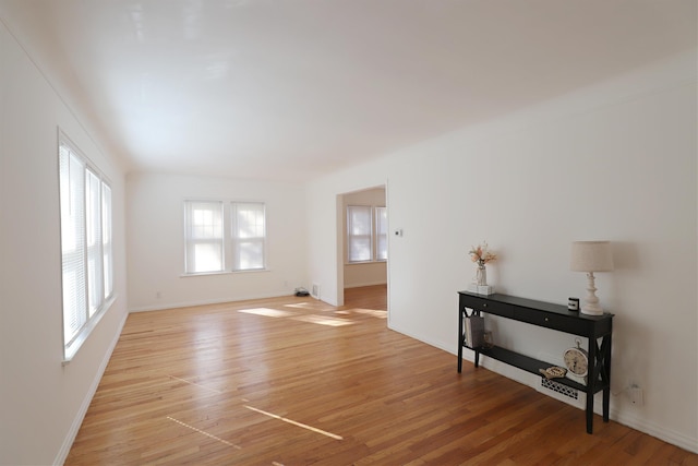 unfurnished room with light wood-style floors and baseboards