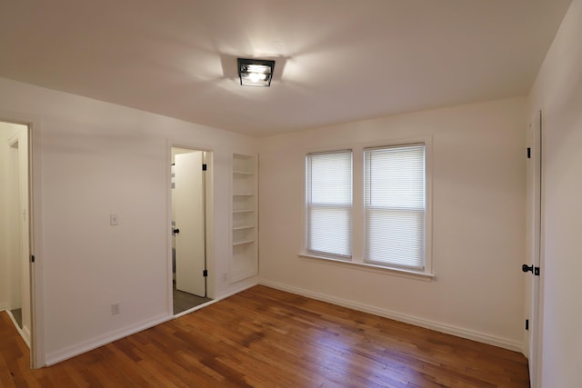 empty room with wood finished floors and baseboards