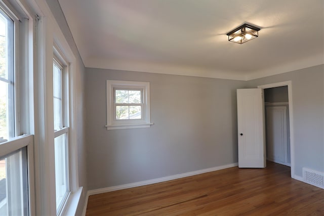 unfurnished bedroom featuring wood finished floors and baseboards