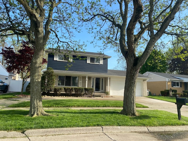 traditional-style house with a garage, concrete driveway, and brick siding