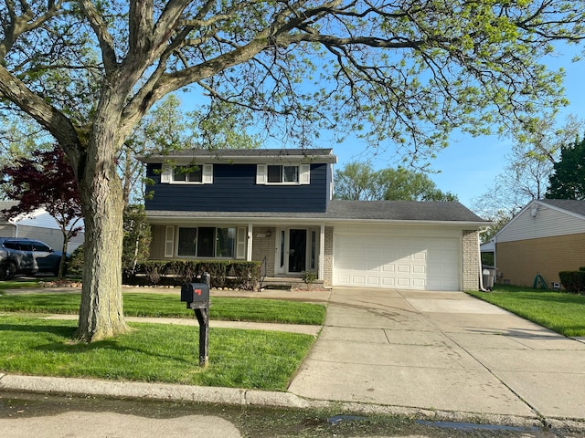 traditional-style home featuring a garage, a front yard, concrete driveway, and brick siding