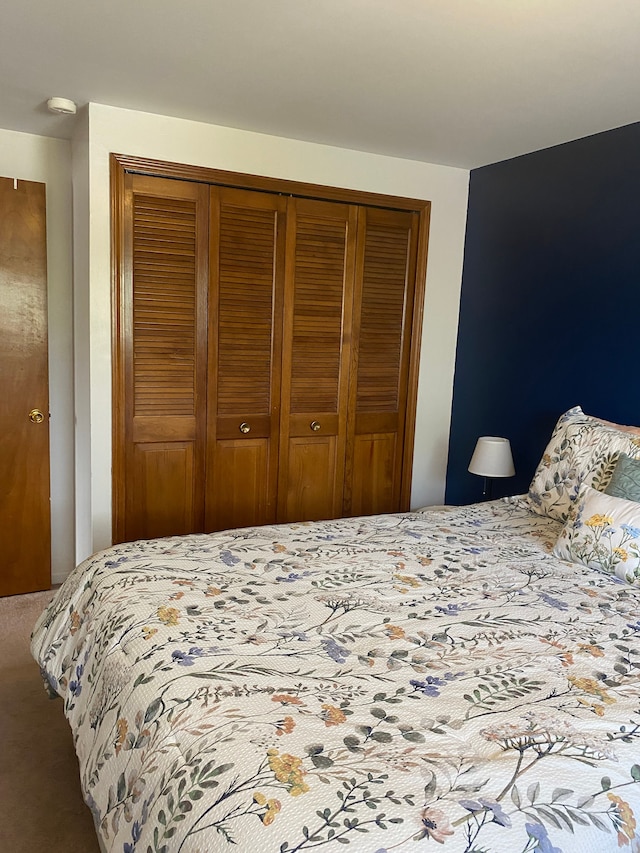 bedroom with a closet and carpet flooring