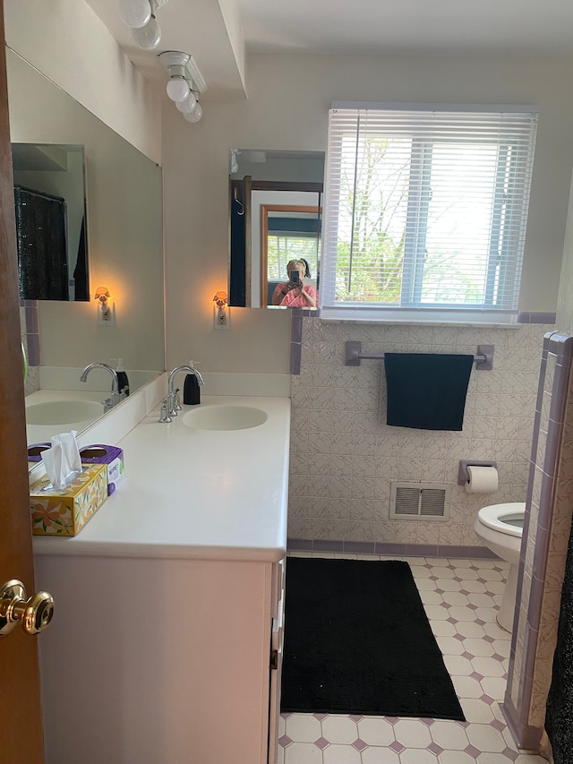bathroom with tile patterned floors, vanity, and toilet