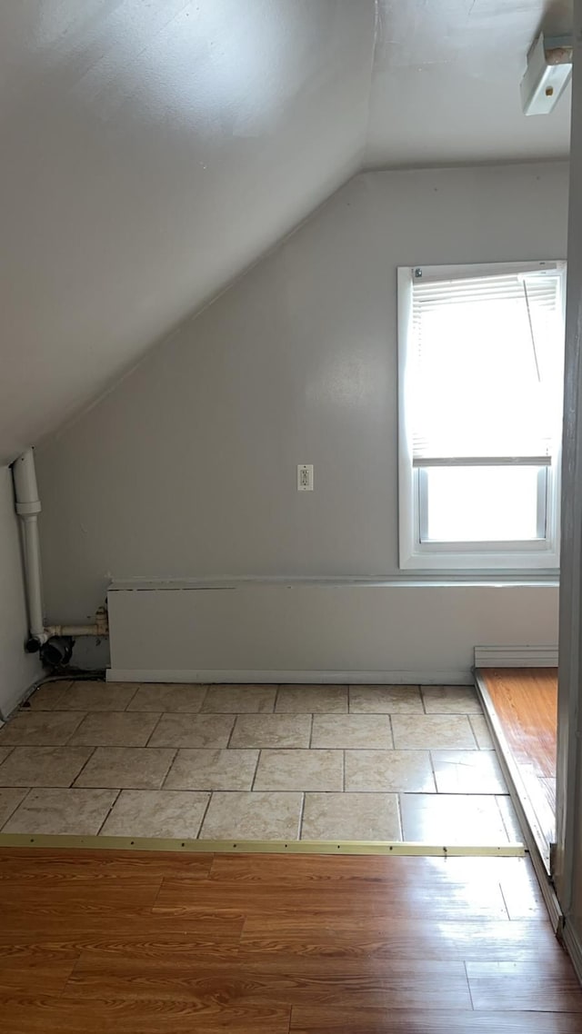 additional living space with lofted ceiling and wood finished floors