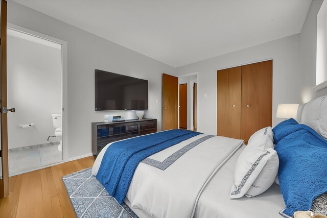 bedroom featuring light wood-style floors, a closet, and baseboards