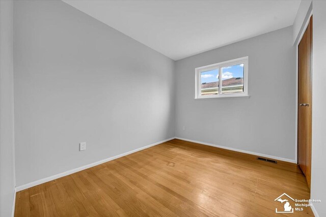 unfurnished bedroom with light wood finished floors and baseboards