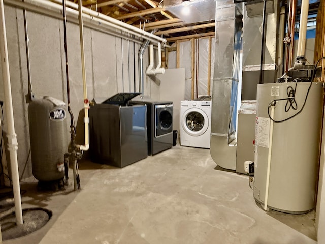 unfinished below grade area with gas water heater, washing machine and dryer, and a water pressure tank