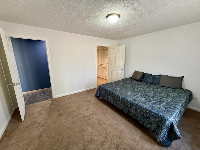 bedroom featuring carpet floors, baseboards, and a textured ceiling