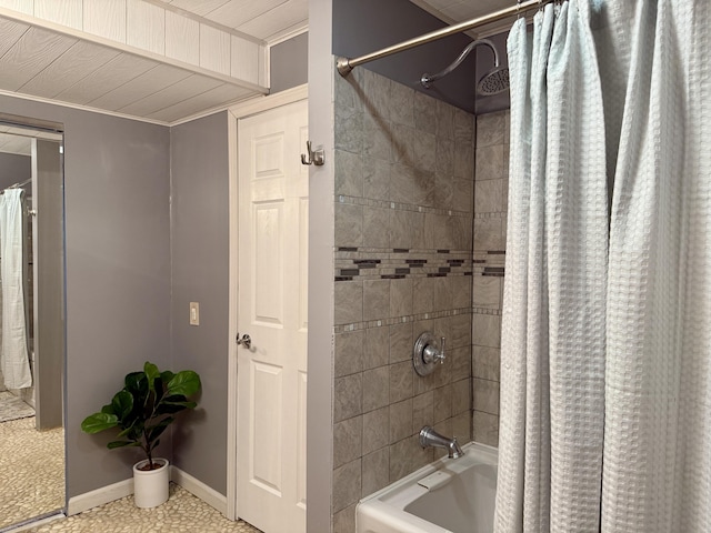 bathroom with shower / bath combo with shower curtain and baseboards