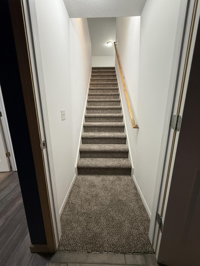 stairs with baseboards and carpet flooring