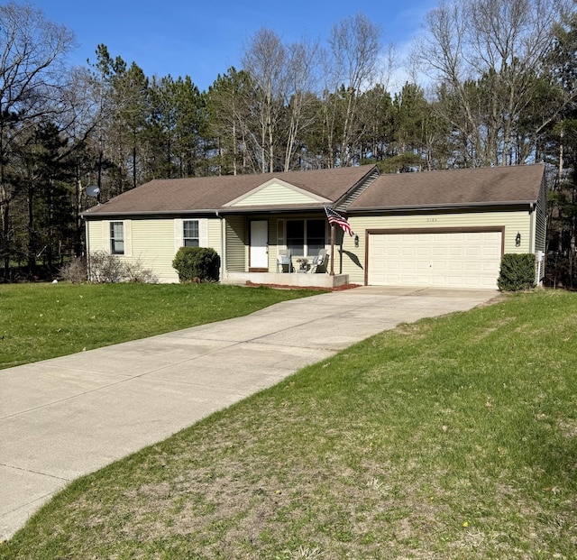 ranch-style home with covered porch, a garage, concrete driveway, and a front lawn