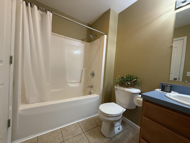 2184 Sugaridge Dr, Muskegon, MI 49445 - bathroom with tile patterned floors, toilet, vanity, shower / bath combo, and baseboards
