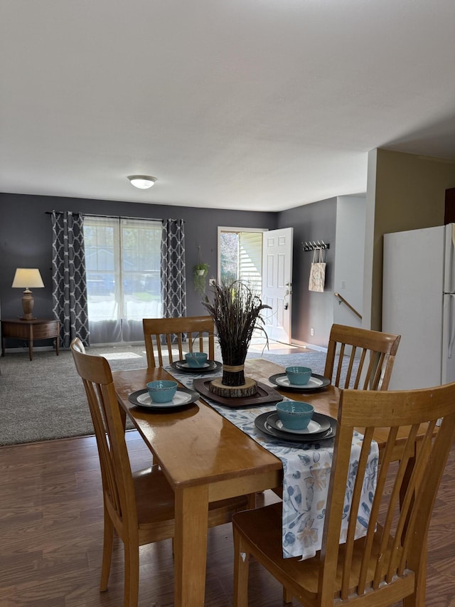 dining space with wood finished floors
