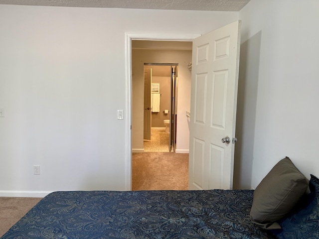 carpeted bedroom with baseboards
