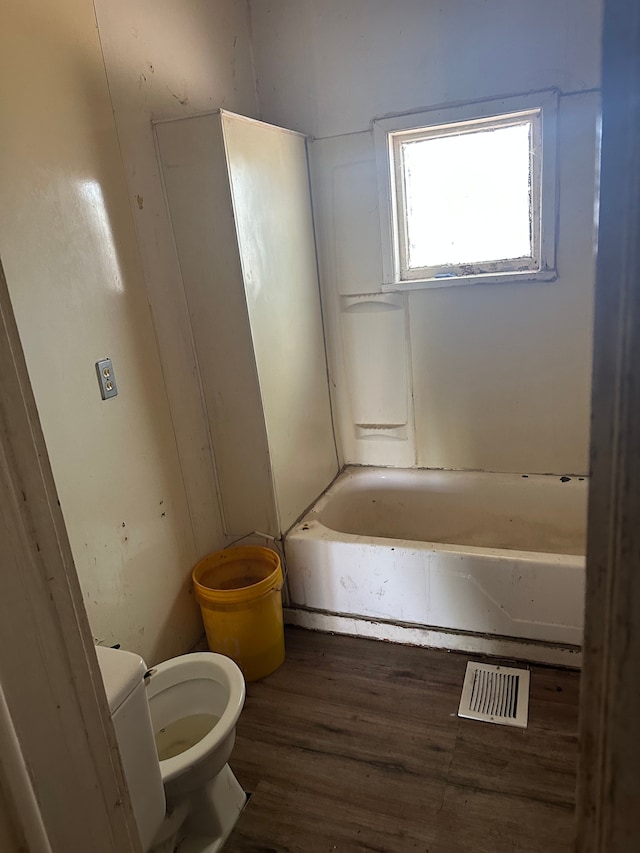full bathroom with toilet and wood finished floors