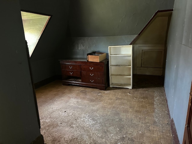 additional living space featuring lofted ceiling