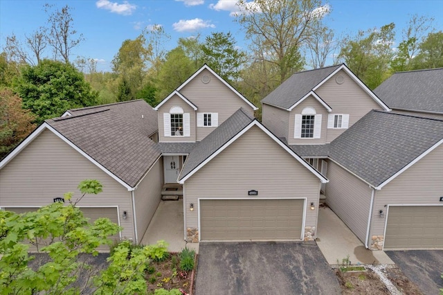 4661 Christopher Pines Dr, Clarkston, MI 48346 - traditional home with a garage, a shingled roof, and asphalt driveway