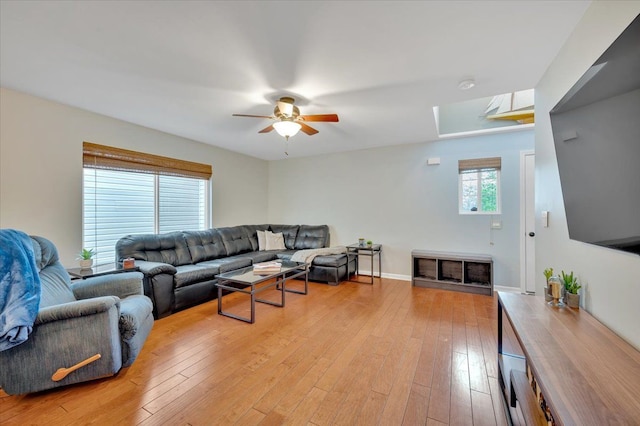 4661 Christopher Pines Dr, Clarkston, MI 48346 - living area featuring ceiling fan, a skylight, and light wood-type flooring