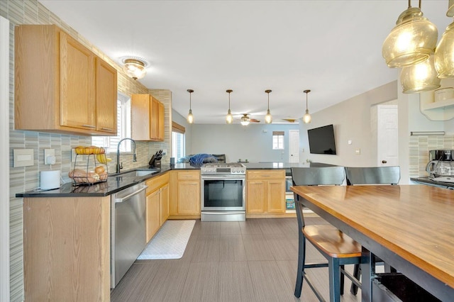 4661 Christopher Pines Dr, Clarkston, MI 48346 - kitchen featuring appliances with stainless steel finishes, a sink, a peninsula, and healthy amount of natural light