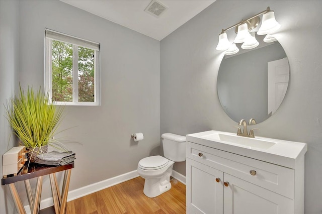 4661 Christopher Pines Dr, Clarkston, MI 48346 - bathroom with wood finished floors, baseboards, toilet, and vanity