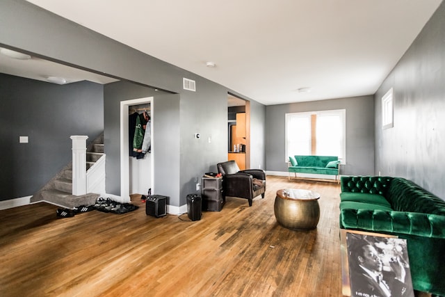 219 Waverly St, Highland Park, MI 48203 - living room with wood finished floors, stairway, and baseboards