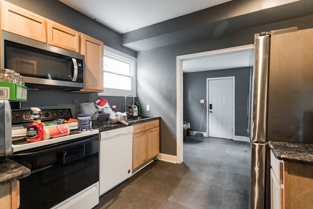 219 Waverly St, Highland Park, MI 48203 - kitchen featuring stainless steel appliances, a sink, light brown cabinets, and dark tile patterned floors