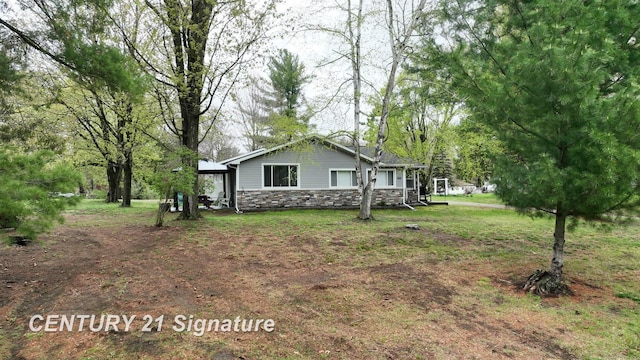 view of home's exterior featuring stone siding and a gazebo