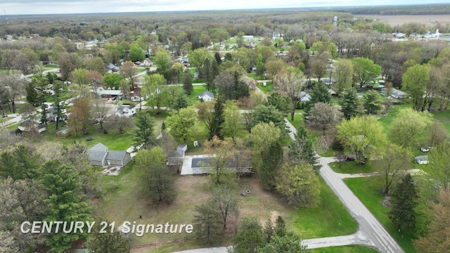 aerial view of property's location featuring a forest