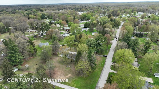 view of property location featuring a forest